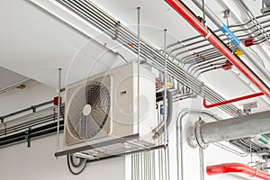 Air conditioner compressor installed and hanging on ceiling wall