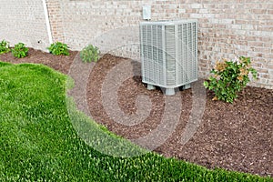 Air conditioner condenser unit standing outdoors