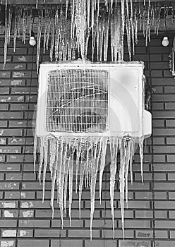 The air conditioner is covered with icicles