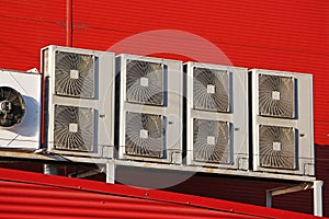 Air conditioner devices on red wall - supermarket air conditioner photo