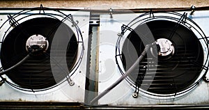 Air conditioner fans are spinning on the street wall. Close-up. Industrial air conditioners