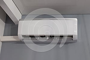 Air conditioner on gray wall room interior background