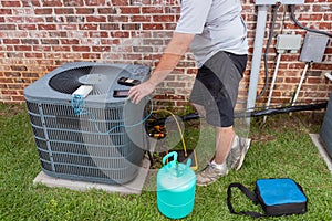 Air Conditioner maintenance with technician adding refrigerant