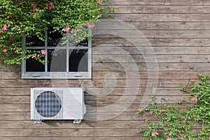 Air conditioner outdoor unit on a blue house with a window. 3d