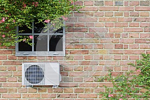 Air conditioner outdoor unit on a brick wall with a window. 3d