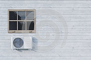 Air conditioner outdoor unit on white house with window. 3d