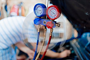 Air conditioner pressure gauge on the background of a car mechanic . mechanic fix the air conditioner