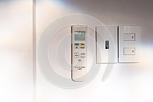 Air conditioner remote control hanging on wall