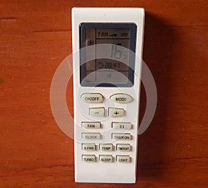 Air Conditioner remote control on wooden wall.