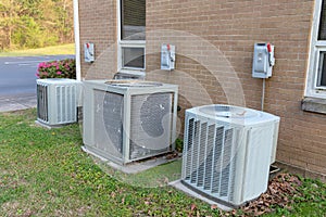 Air Conditioner units with cut off switches next to commerical building