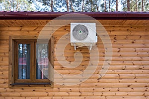 air conditioner on the wall of a wooden ecological country house or cottage