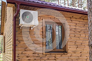 air conditioner on the wall of a wooden ecological country house or cottage