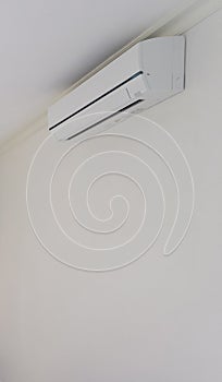 Air conditioner on white wall room interior