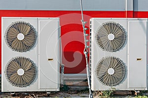 Air conditioners or HVAC or climate control systems on backyard of building