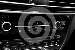 Air conditioning button inside a car. Climate control AC unit in the new car. Modern car interior details. Car detailing. Black pe