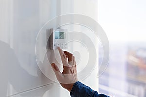 The air conditioning and heating control panel for the apartment and office is located on a white wall