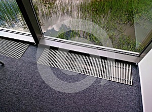 air conditioning or heating exhaust from the floor under window of the office