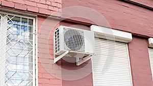 Air conditioning on red brick building wall