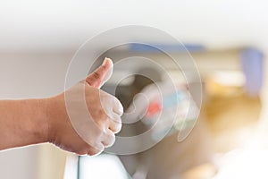 Air Conditioning repair man hand giving thumb up as sign of success, repairman fixing air conditioning system