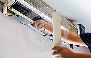 Air Conditioning Repair, Repairman fixing air conditioning system, Male technician service for repair and maintenance of air