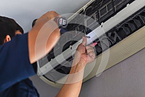 Air Conditioning Repair, Repairman fixing air conditioning system, Male technician service for repair and maintenance of air