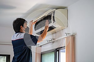 Air Conditioning Repair, Repairman fixing air conditioning system, Male technician service for repair and maintenance of air