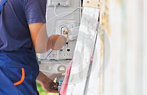 Air Conditioning Repair, repairman fixing air conditioning system, Technicians check air conditioning system refrigerant recharge