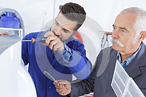 air conditioning repairman and apprentice