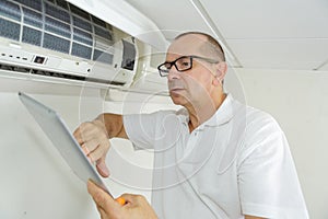 air conditioning repairman with clipboard