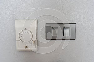 Air conditioning setting panel with light switch on the house wall