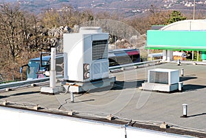 Air conditioning system assembled on top of a building / Air vents on top of commercial building / Air cooled water chillers top.