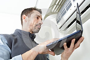 air conditioning technician preparing to install new air conditioner