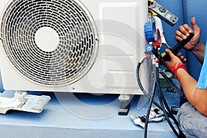 Air Conditioning Technician is Repairing air conditioner ,Because of leakage of air solution at the pipe joint