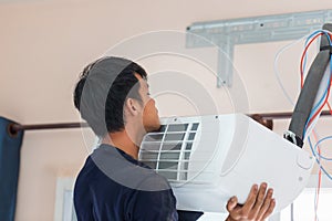 Air conditioning technicians install new air conditioner, Technician service for repair and maintenance of air conditioners