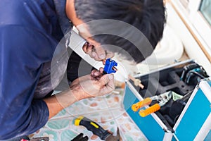 Air conditioning technicians install new air conditioner, Technician service for repair and maintenance of air conditioners