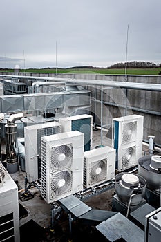 Air conditioning units on roof with other parts of ventilation system