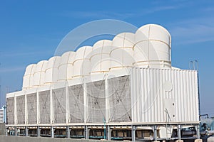 Air cooling tower for HVAC chilling units at building rooftop outdoor blue sky