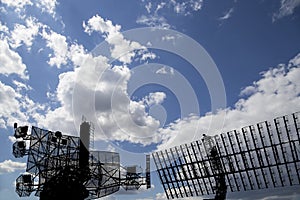 Air defense radars of military mobile anti aircraft systems, modern army industry on background beautiful clouds and sky, Russia