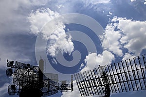 Air defense radars of military mobile anti aircraft systems, modern army industry on background beautiful clouds and sky, Russia