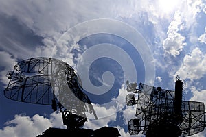 Air defense radars of military mobile anti aircraft systems, modern army industry on background beautiful clouds and sky, Russia