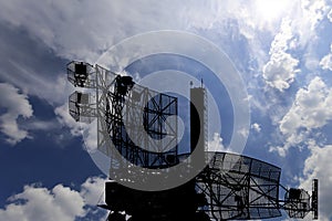 Air defense radars of military mobile anti aircraft systems, modern army industry on background beautiful clouds and sky, Russia