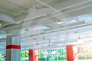 Air duct, air conditioner pipe, fire sprinkler and wiring system. Building interior. Ceiling lamp light with opened light.
