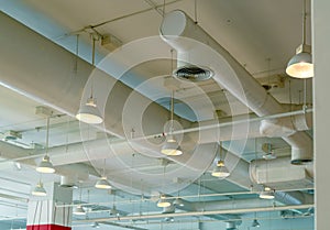 Air duct, wiring and plumbing in the mall. Air conditioner pipe, wiring pipe, and plumbing pipe system. Ceiling lamp light with