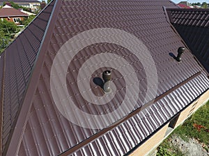 Air ducts on metal roof. The roof of corrugated sheet. Roofing of metal profile wavy shape
