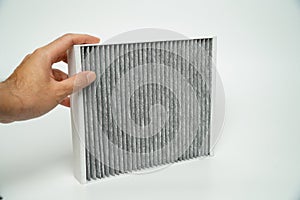 Air filter for car on a white background. Close-up.Car cabin air filter. Car air cleaning spare parts