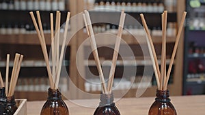 Air flavors, fragrant oils in glass bottles with wooden sticks. Close-up.