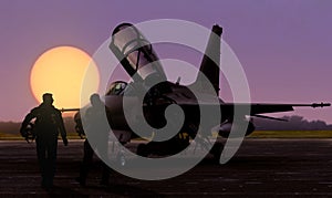 Air force jet fighter pilots silhoutte at sunset on military base airfield