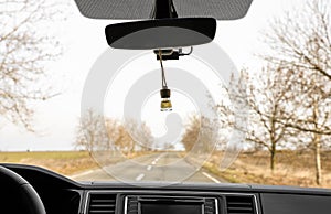 Air freshener hanging on view mirror in car