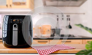 Air fryer machine cooking potato fried in kitchen.  Lifestyle of new normal cooking