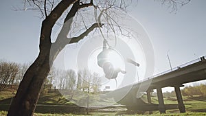 Air gymnastics woman performs acrobatics tricks on aerial hoop